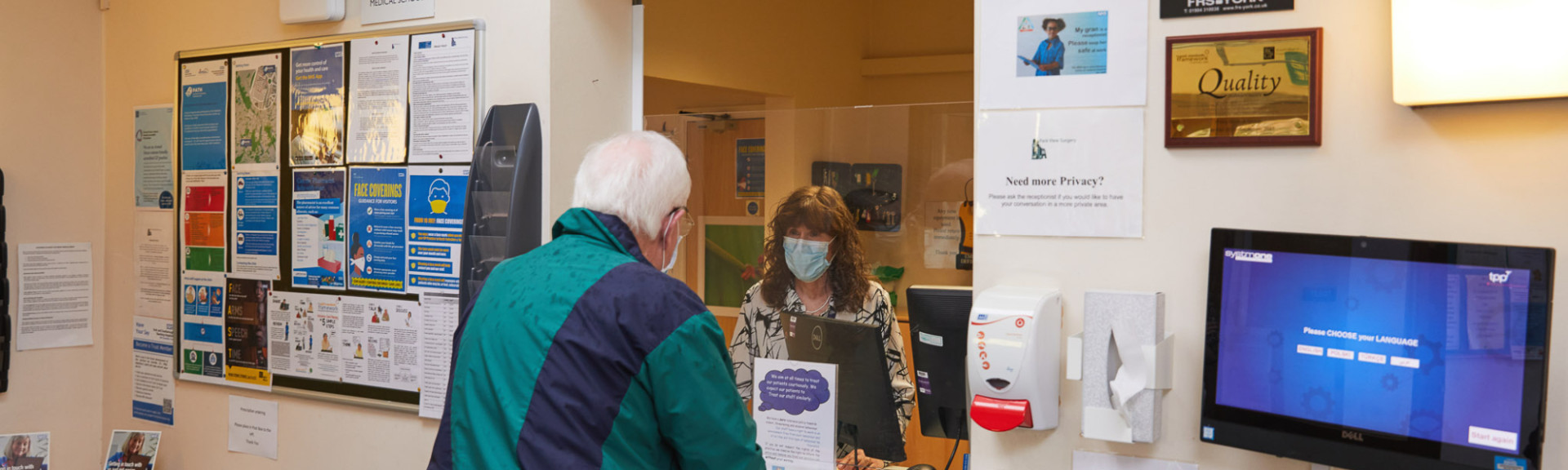 A photo showing a patient at the Park View surgery reception desk