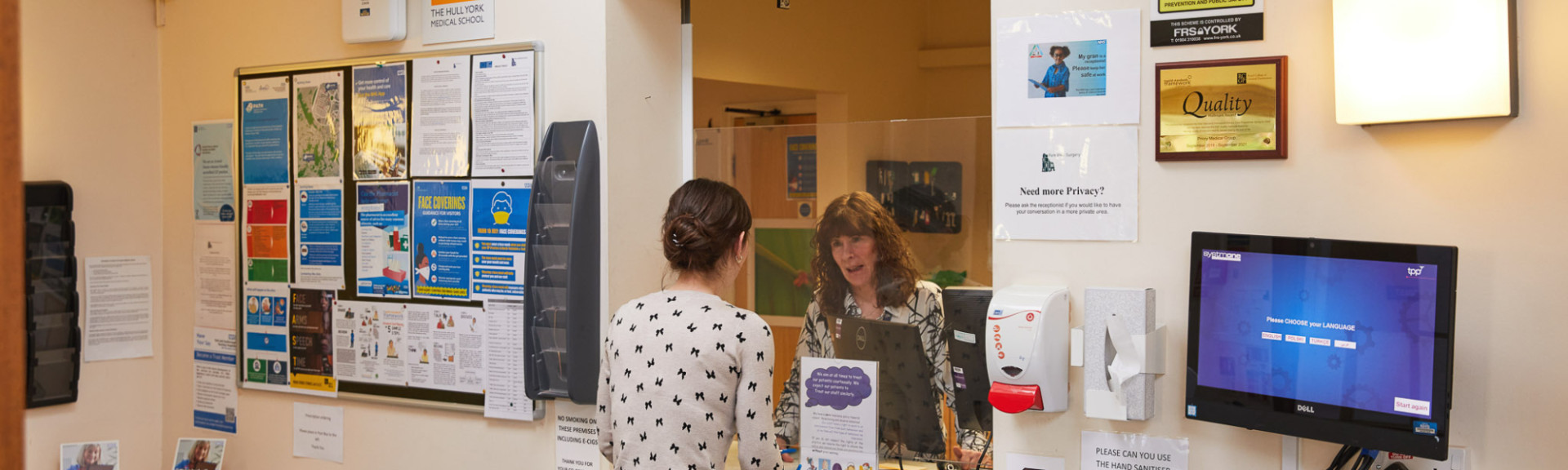 A photo showing a patient speaking to a receptionist at park view surgery