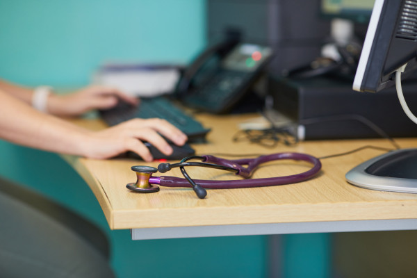 A photo showing a stethoscope on a desk